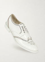 Patent white wingtip derby shoes with black brogueing, front three-quarter view - Luke Grant-Muller
